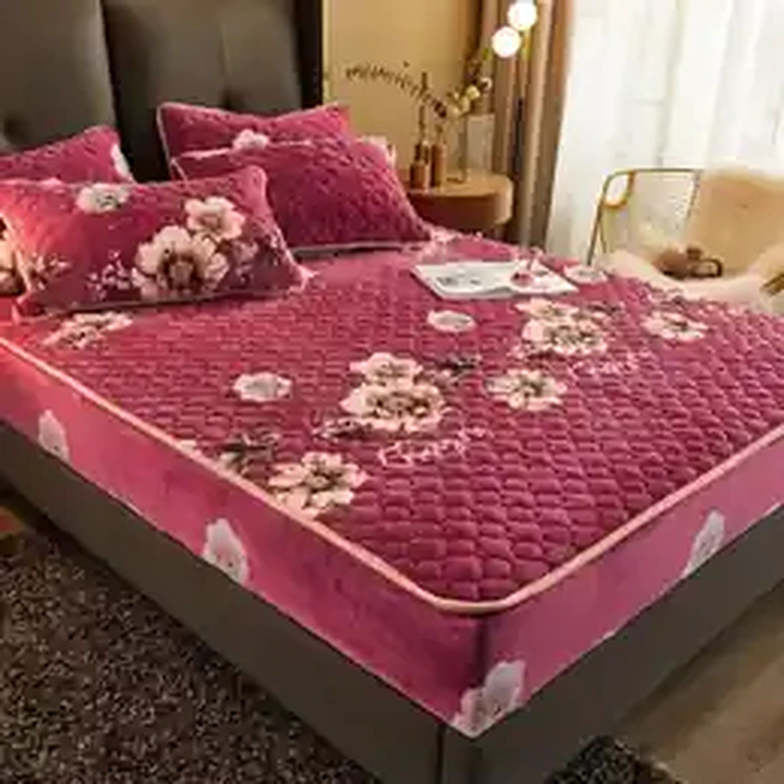 Pink plush mattress protector styled on a bed