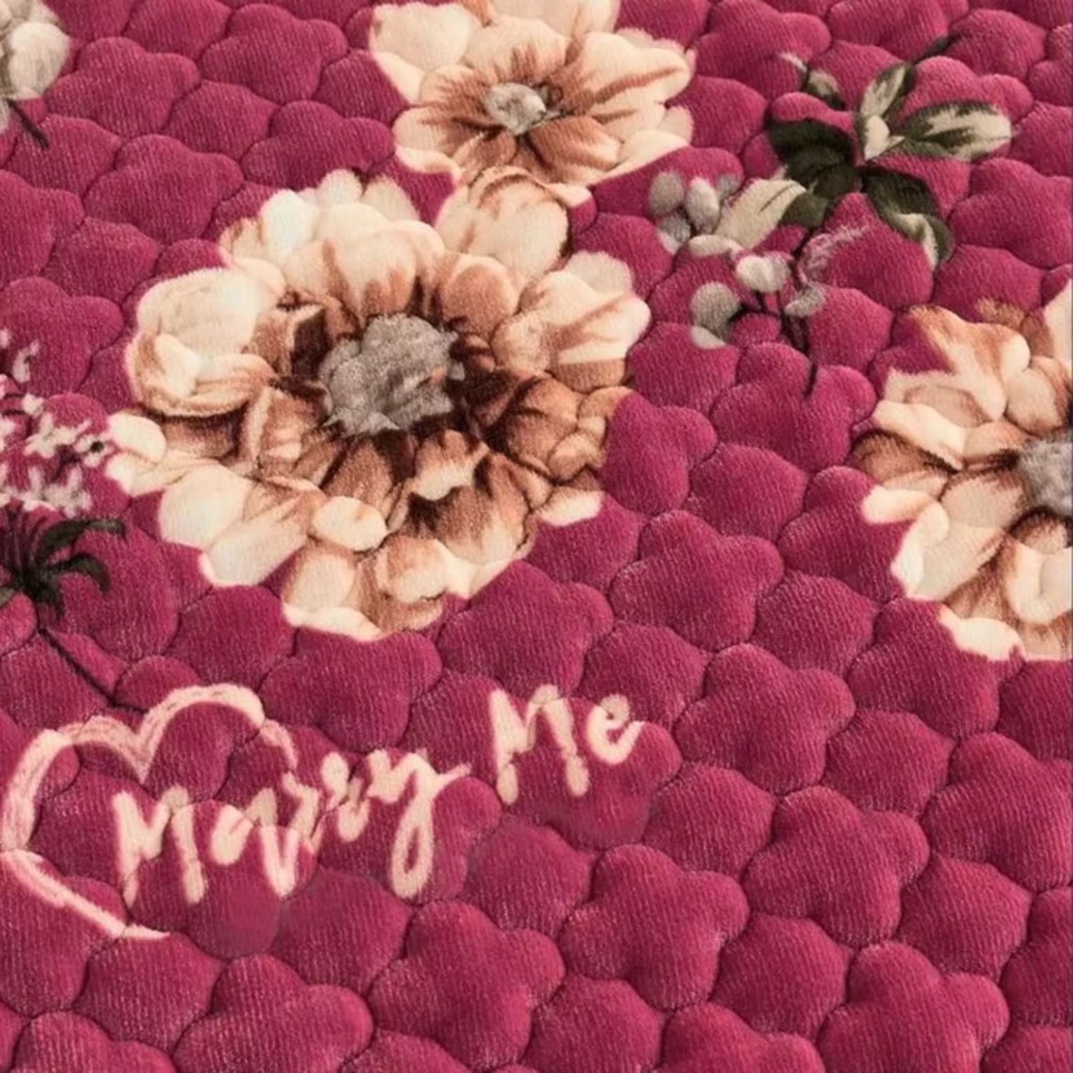 Close-up of pink quilted plush mattress protector texture